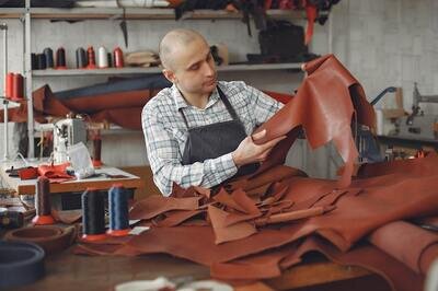 man examining leather